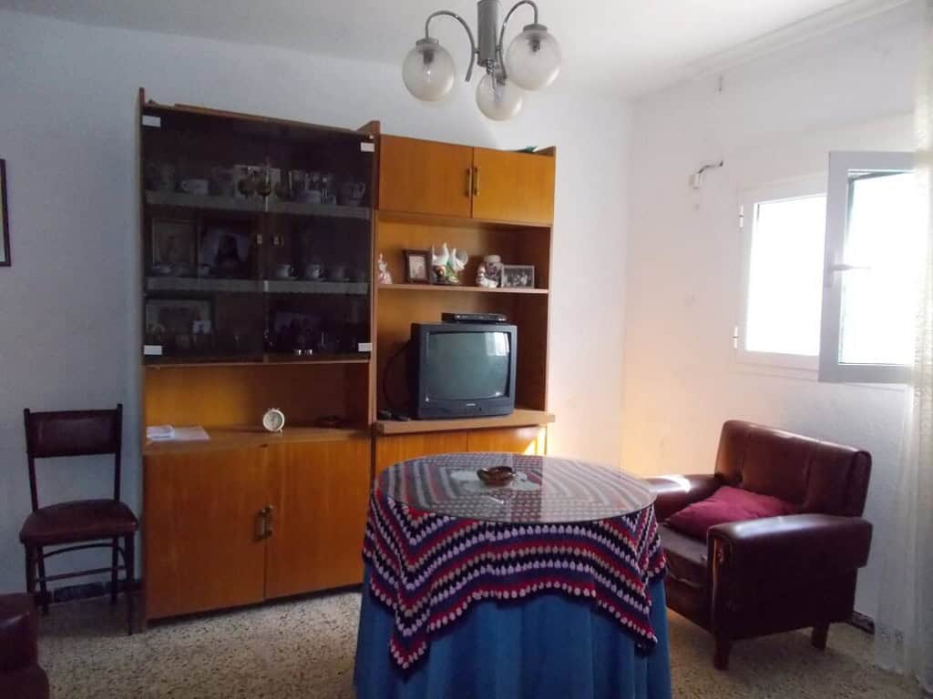 Charming village property in Seron, Almeria, featuring a simple living room with vintage furniture a.