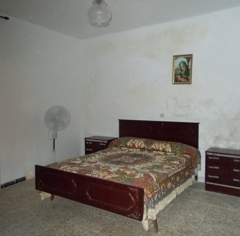 Charming bedroom in a village property in Seron, Almeria, featuring simple furnishings and a cozy at.