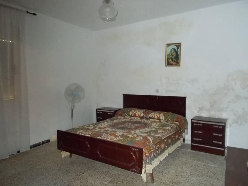 Charming bedroom in a village property in Seron, Almeria, featuring simple furnishings and a cozy at.