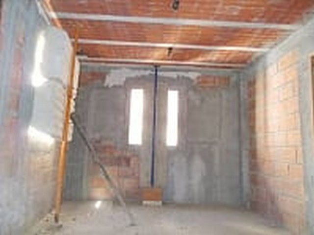 Construction site of a village property in Seron, Almeria with unfinished brick walls and wooden cei.