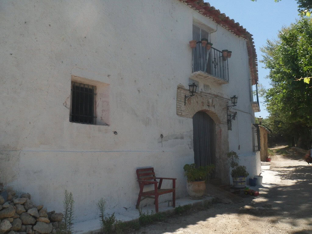 Farm property in Zujar, Granada with traditional white walls and rustic charm.