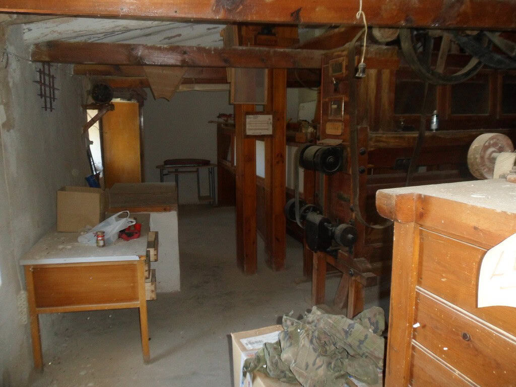 Farm property interior with rustic wooden beams and traditional furnishings in Zujar, Granada.