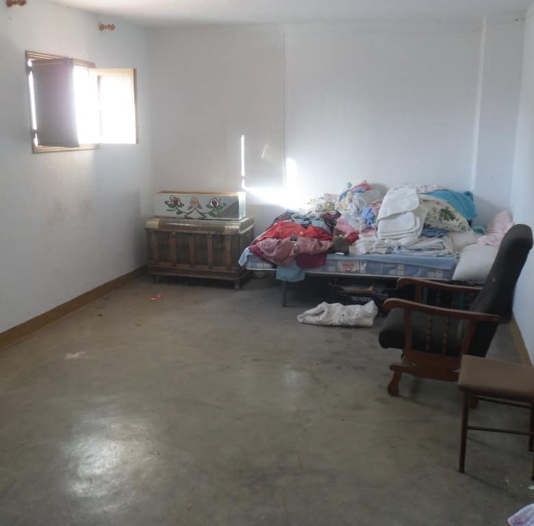 Interior of a modest town house in Freila, Granada with simple furnishings and natural light.