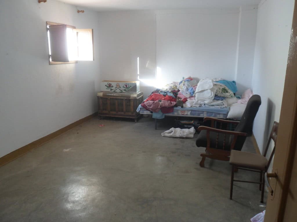 Interior of a modest town house in Freila, Granada with simple furnishings and natural light.