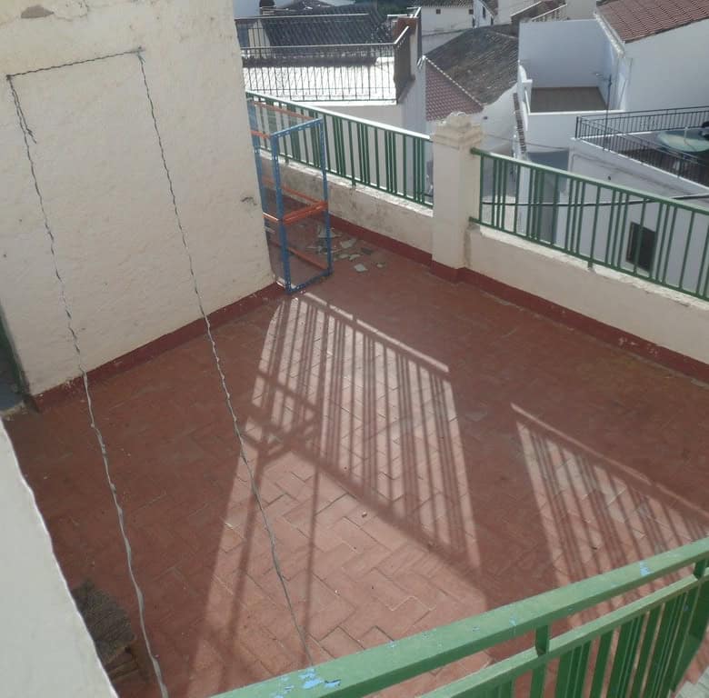 Balcony of a town house in Freila, Granada with views of neighboring rooftops and a spacious outdoor.