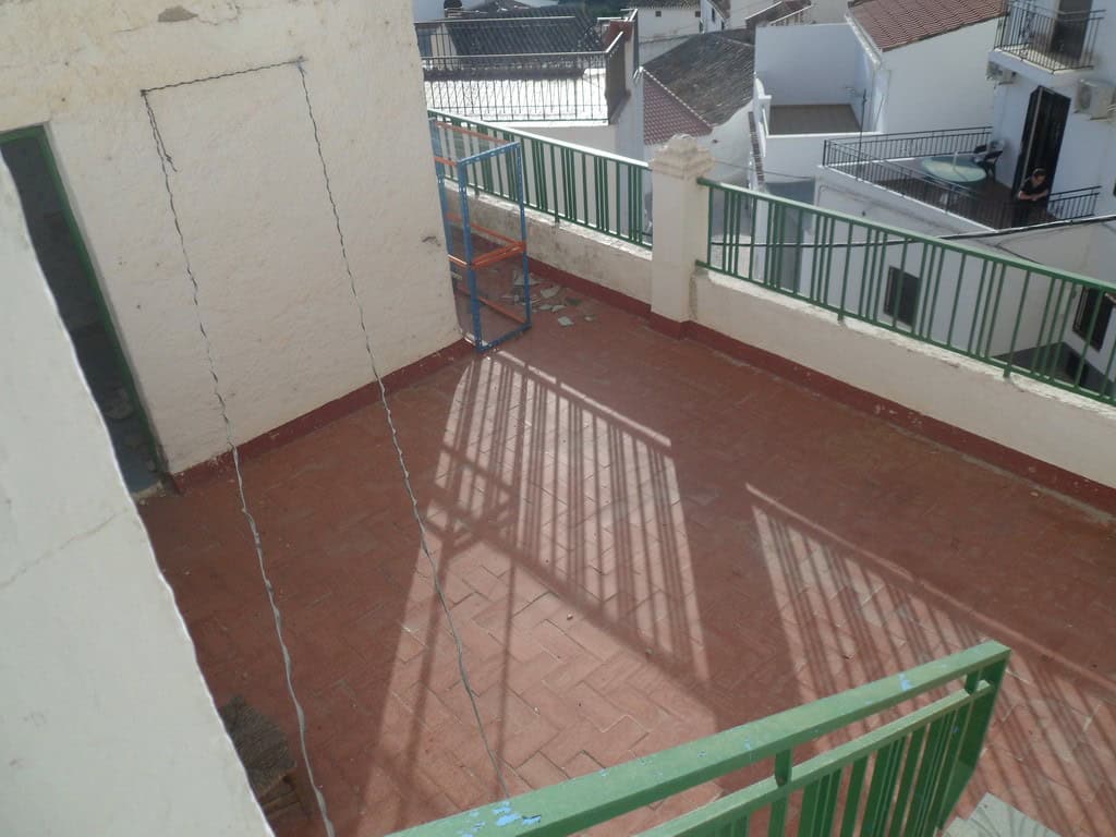 Balcony of a town house in Freila, Granada with views of neighboring rooftops and a spacious outdoor.