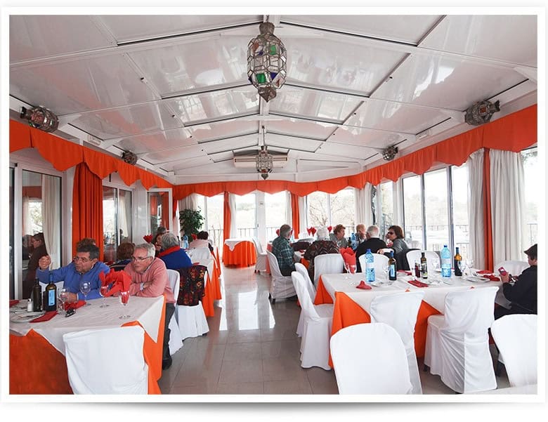 Restaurant interior with white and orange decor in Baza, Granada.