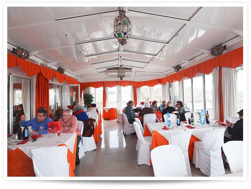 Restaurant interior with white and orange decor in Baza, Granada.