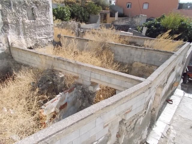 Village property in Lucar, Almeria with dry grass and stone boundary walls.