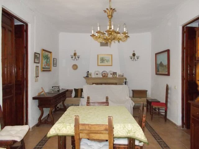 Village property interior with traditional decor in Tijola, Almeria, featuring a dining area and vin.