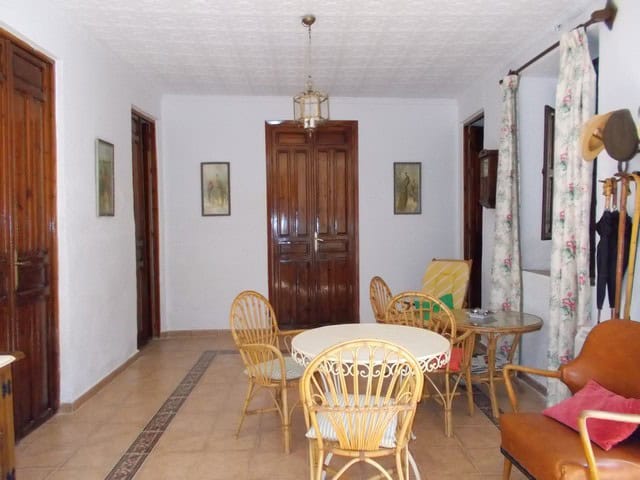 Charming village property interior in Tijola, Almeria, featuring a cozy dining area with wooden furn.