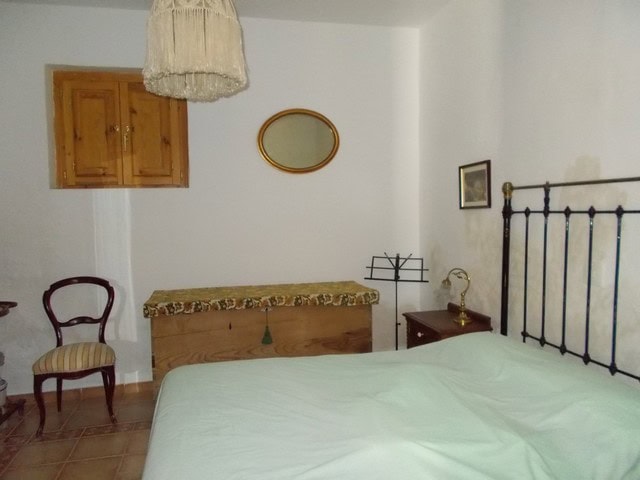 Charming bedroom in Tijola village property, featuring a simple interior with wooden furniture and a.