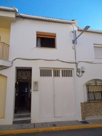 Charming village house in Cela, Almeria, featuring a white facade and traditional architecture.