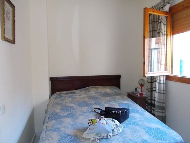 Village property bedroom with a double bed and natural light from window.
