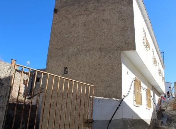 Charming village house in Zujar, Granada, with traditional architecture and scenic surroundings.