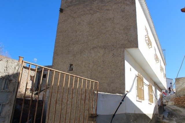 Charming village house in Zujar, Granada, with traditional architecture and scenic surroundings.