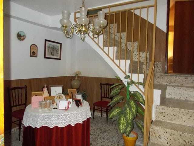 Charming village home interior with staircase, dining area, and decorative elements in Zujar, Granad.