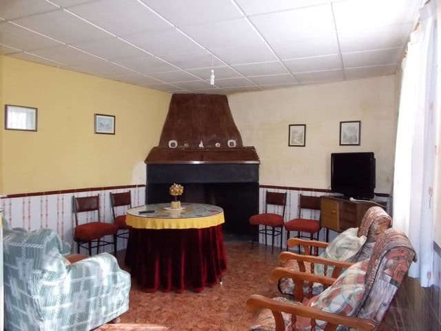 Charming interior of a village property in Zujar, Granada, featuring a cozy living room with traditi.
