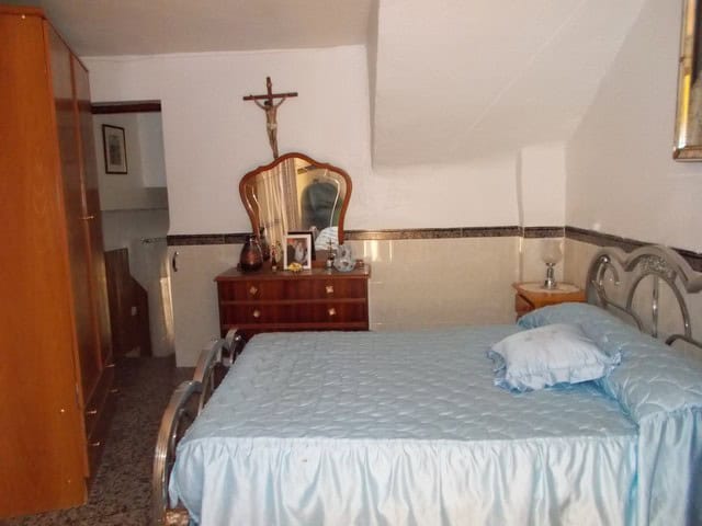 Charming bedroom in a village property in Zujar, Granada, featuring traditional decor and peaceful s.