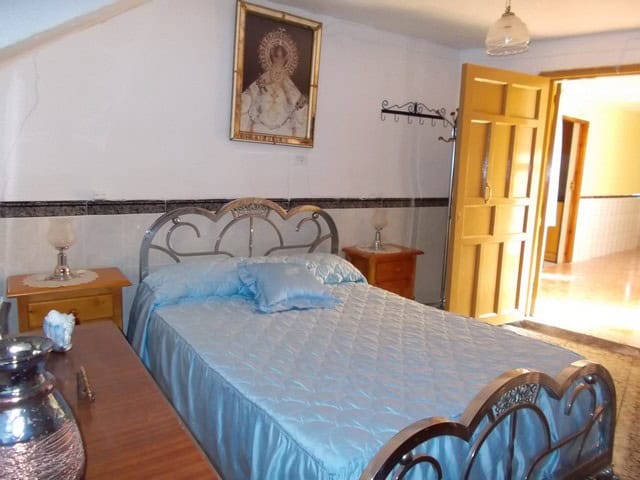 Charming bedroom in a village property in Zujar, Granada, featuring traditional decor and a cozy atm.