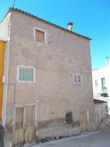 Charming village house in Zujar, Granada with rustic exterior and potential for renovation. Ideal fo.