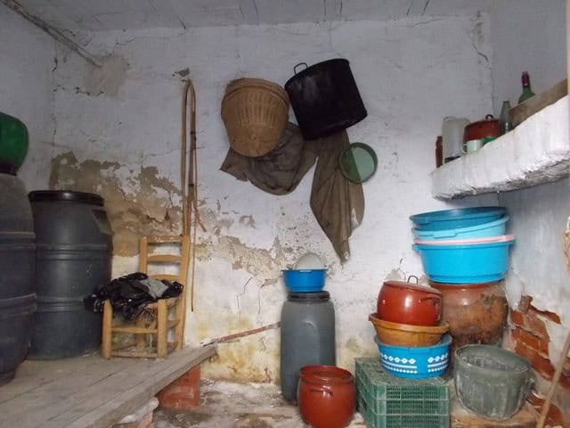 Charming rural property in Zujar, Granada, with traditional storage containers and rustic decor.