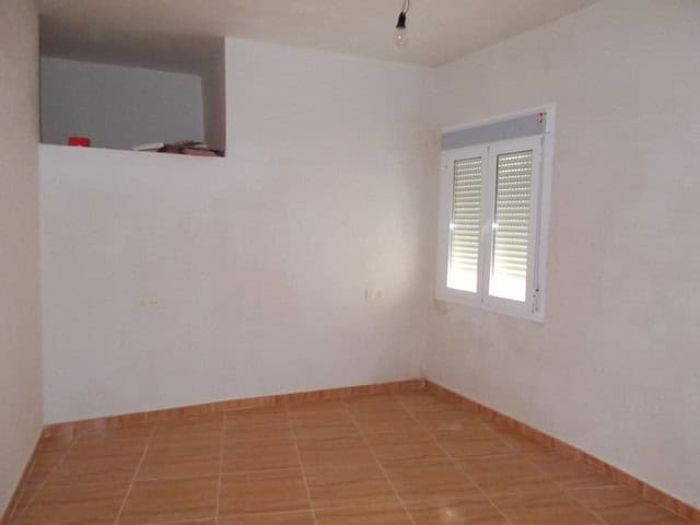 Village property with white walls and a window in Lucar, Almeria, ideal for renovation.