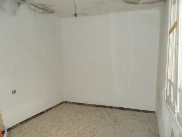 Interior of a town house in Tijola, Almeria, showing unfinished walls and ceiling.