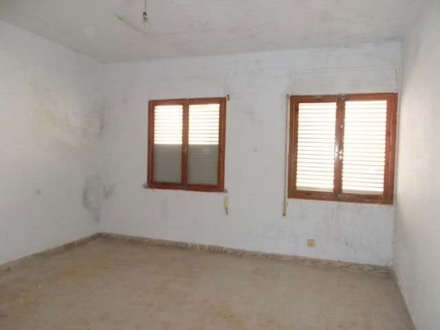 Town house interior with two windows in Tijola, Almeria, ready for renovation.