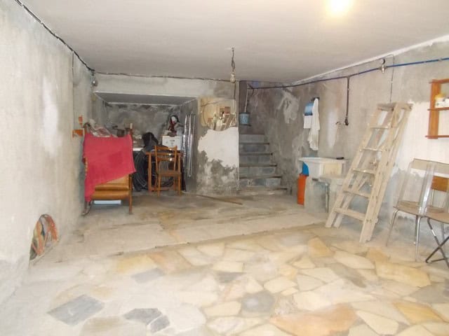 Spacious basement area in a village property in Seron, Almeria, featuring unfinished walls and basic.