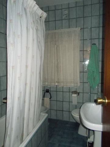 Cozy bathroom with bathtub, toilet, and sink in a village property in Seron, Almeria.
