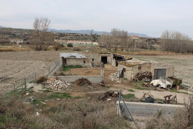 Rural property for sale in Caniles, Granada, featuring rustic buildings and open land. Ideal for ren.