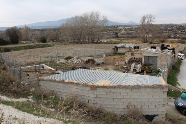 Rural property for sale in Caniles, Granada, with land and outbuildings in a scenic countryside sett.