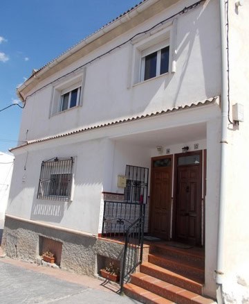 Traditional village property in Hijate, Almeria, featuring whitewashed walls and a welcoming entranc.