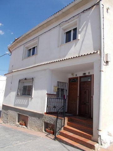 Traditional village property in Hijate, Almeria, featuring whitewashed walls and a welcoming entranc.