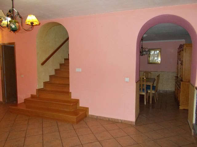 Interior view of a town house in Tijola, Almeria, featuring a staircase and dining area.