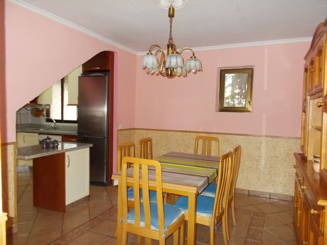 Charming town house interior in Tijola, Almeria, featuring a dining area with wooden furniture and a.