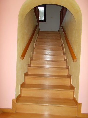Interior staircase of a town house in Tijola, Almeria, with wooden steps and handrails.