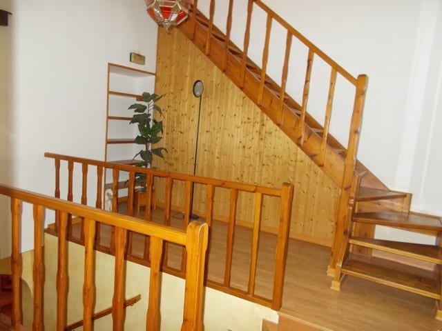 Town House interior with wooden staircase and railing in Tijola, Almeria.