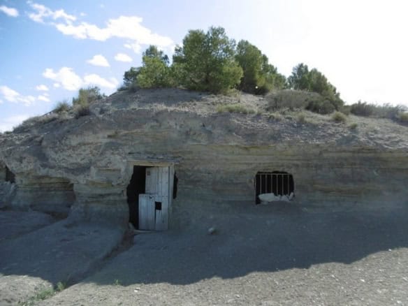 Cave house built into a natural rock formation in Benamaurel, Granada, offering rustic charm and uni.