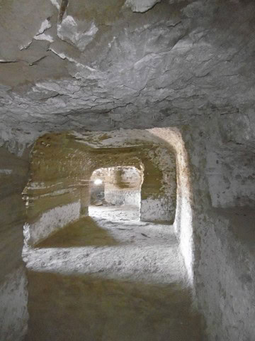 Cave house interior with carved tunnels and natural rock formations in Benamaurel, Granada.