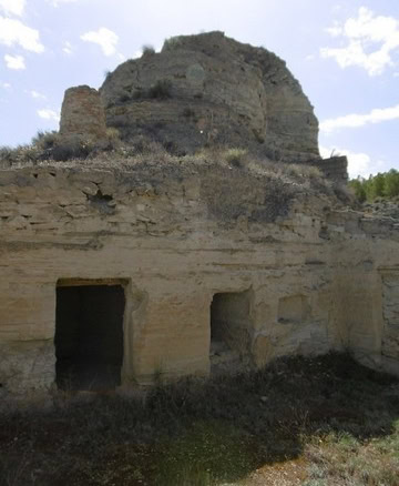 Ancient cave house built into rocky hillside in Benamaurel, Granada, showcasing traditional rural ar.
