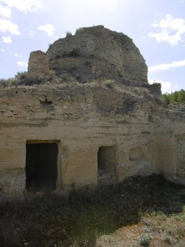 Ancient cave house built into rocky hillside in Benamaurel, Granada, showcasing traditional rural ar.
