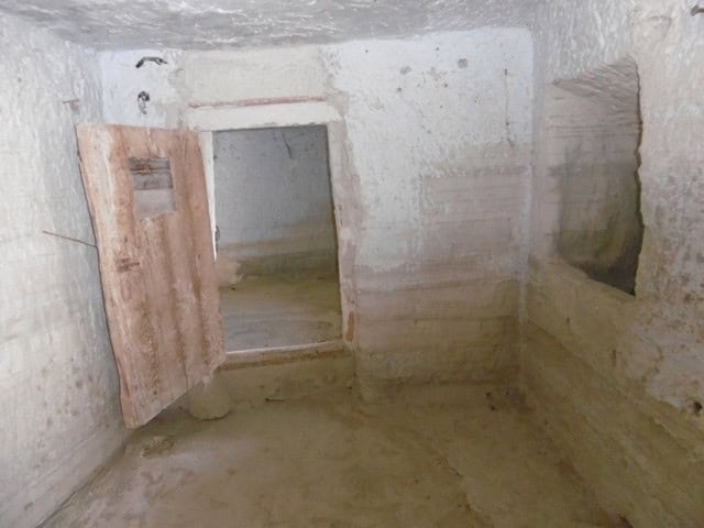 Authentic cave house interior in Benamaurel, Granada, showcasing rustic stone walls and unique archi.