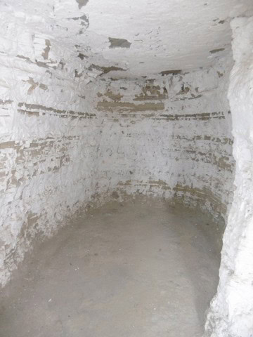 Ancient cave house interior with whitewashed walls in Benamaurel, Granada, showcasing traditional ru.