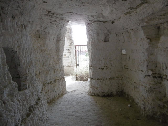 Cave house interior in Benamaurel, Granada, showcasing natural rock walls and rustic charm.
