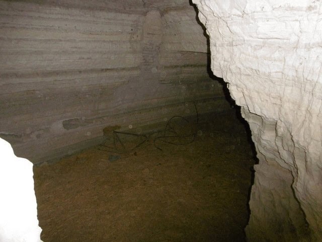 Cave house interior in Benamaurel, Granada, showcasing natural rock walls and rustic charm.