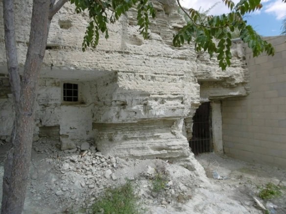 Cave house built into natural rock formation in Benamaurel, Granada, Spain.