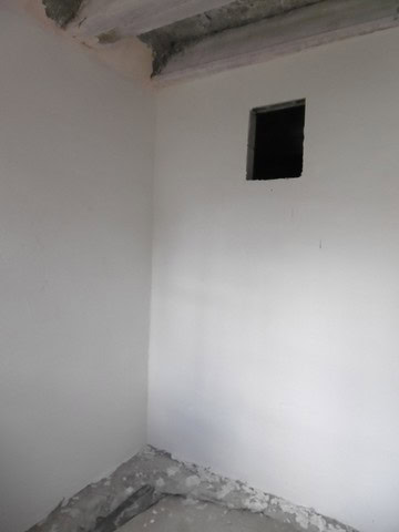 Cave house interior with white walls and small window in Benamaurel, Granada.