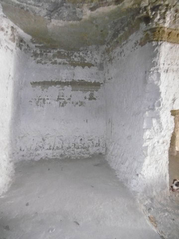 Historic cave dwelling in Benamaurel, Granada, with rustic stone walls and unique underground archit.